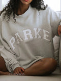 Oversized varsity sweatshirt in grey with white letters, front view
