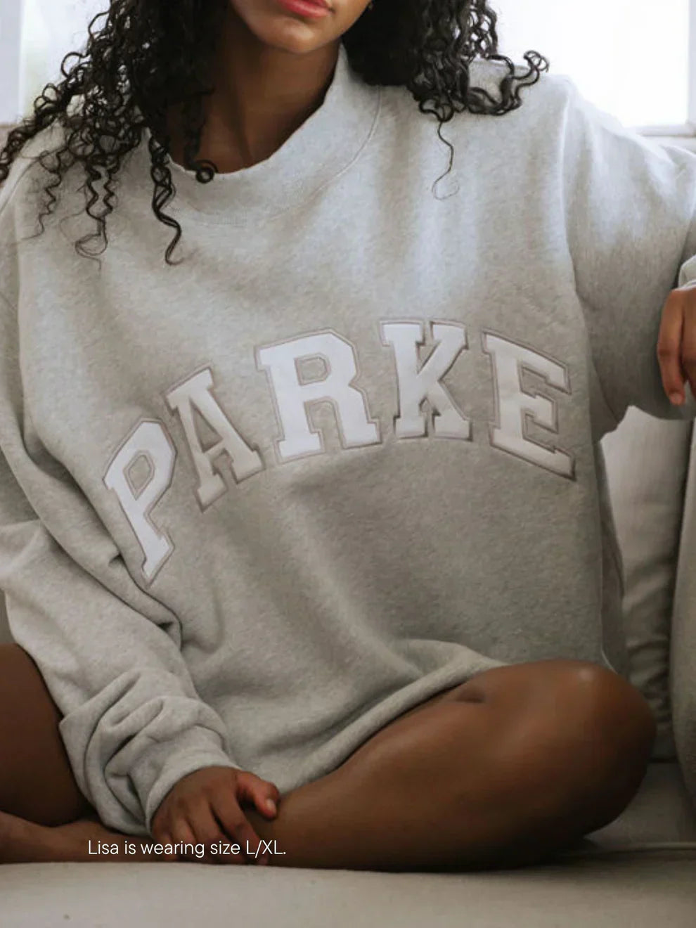 Oversized varsity sweatshirt in grey with white letters, front view