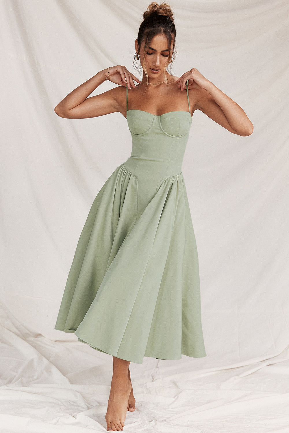 Elegant flattering midi dress in light green, front view