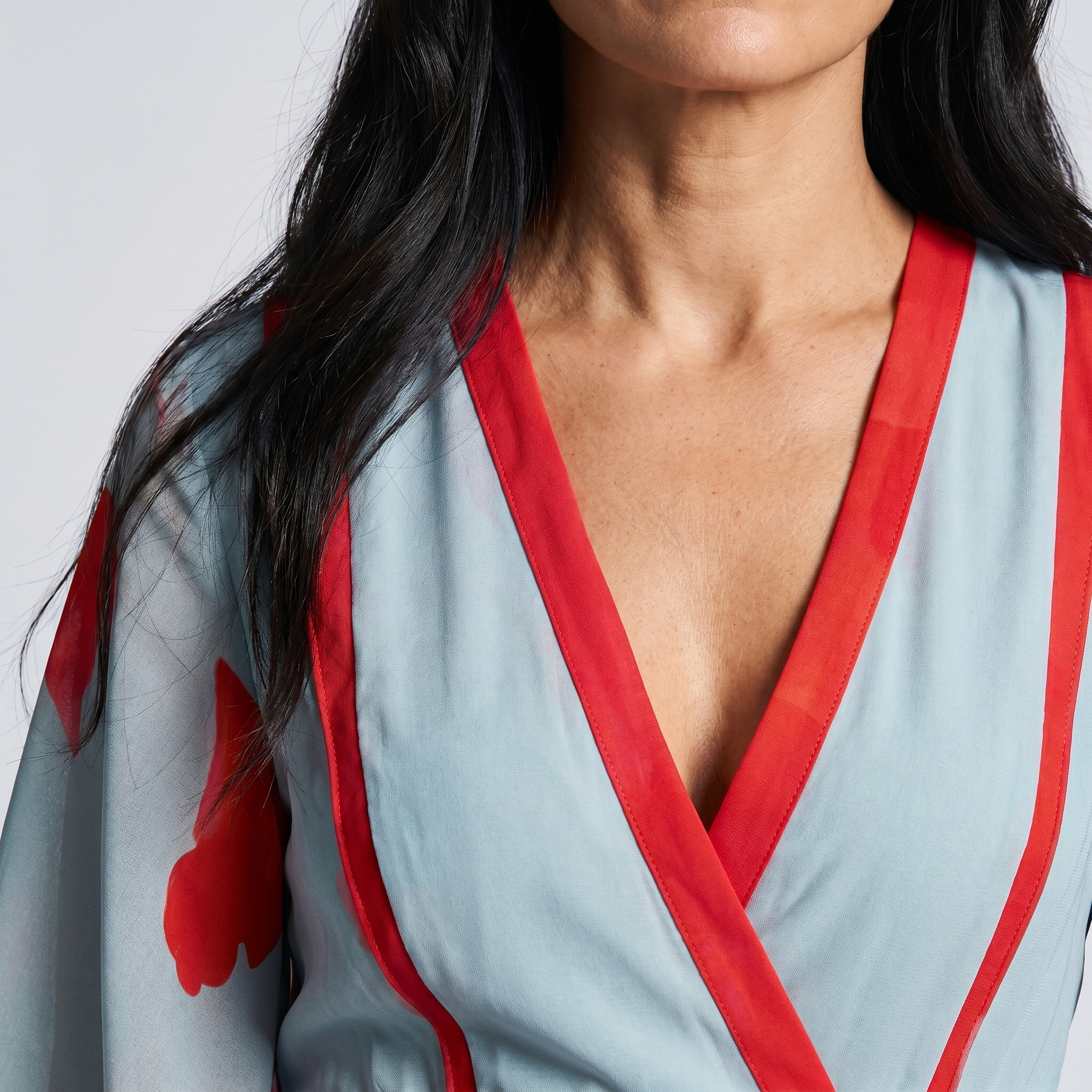 Close-up detail of red trim on floral wrap maxi dress